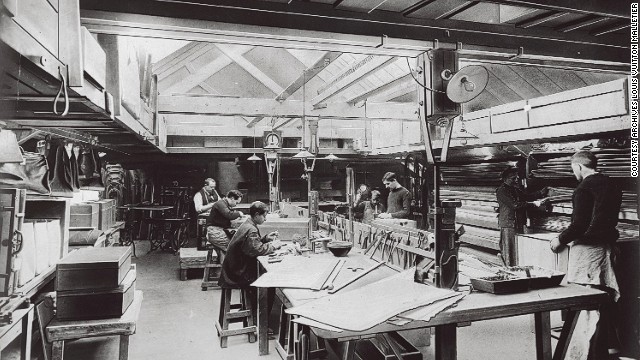 Artisans work in a room bathed in natural light in this image from 1902. This is where fine touches that distinguished Vuitton products were made. 