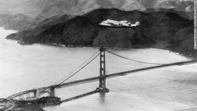 The Lockheed Electra 'Flying Laboratory' piloted by Earhart and Fred Noonan flies over the Golden Gate bridge in Oakland, California, at the start of a planned around-the-world flight on March 17, 1924. The trip had to be abandoned after the plane crashed on takeoff in Hawaii.