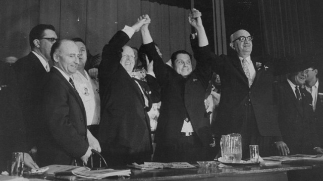 Hoffa, center, stands with other officials at the Teamsters convention, where he made a successful bid for control of the union in 1957.