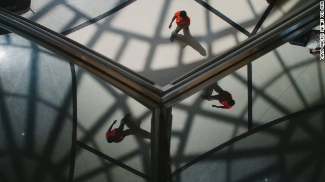 Passengers are reflected in the ceiling of the Domestic Terminal atrium.