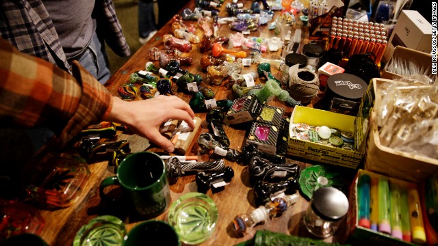 Attendees look at glass pipes used for smoking marijuana being sold at Hempfest on April 20 in Seattle. 