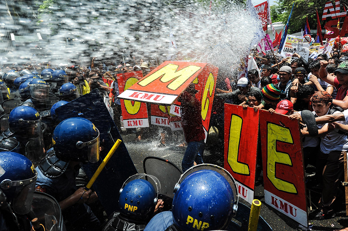 Anti-US protesters clash with riot police using water cannons near the American embassy.