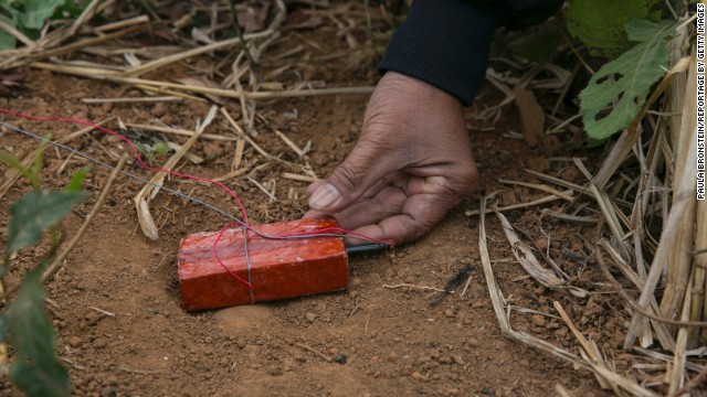 A member of the UXO Lao clearance team gets ready to detonate munitions found after a day of work in the Lateuang village. The government-run organization has been clearing land mines in Laos since 1996.