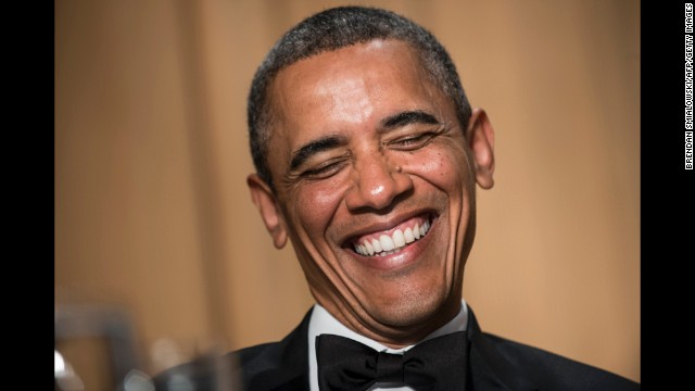 Obama laughs at the comments made during the dinner.