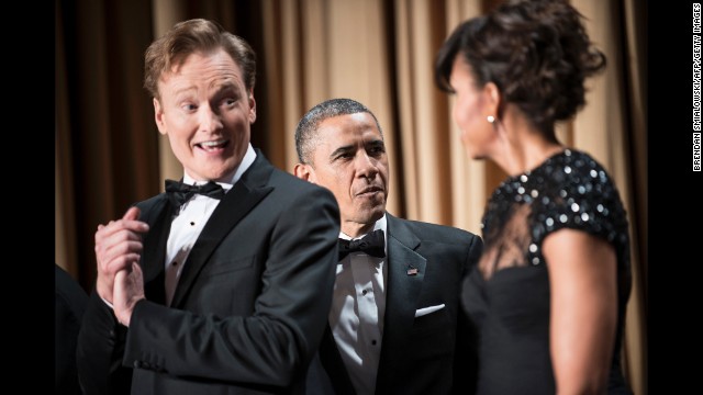 Comedian Conan O'Brien smiles as the president and first lady Michelle Obama arrive at the dinner.