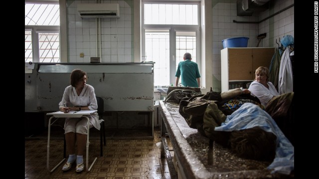 Medical staff prepare to clean the body of a pro-Russian militant at the Kalinina morgue in Donetsk on May 27.