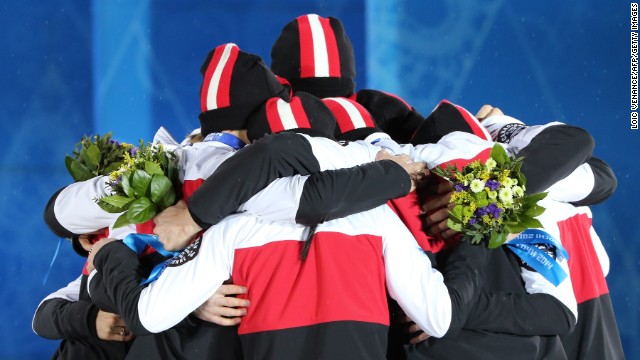 Canada's figure skating team celebrates winning silver on February 10.