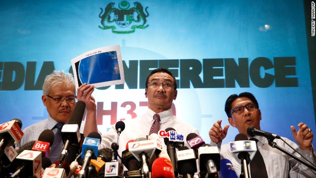 Malaysian Transportation Minister Hishamuddin Hussein, center, shows maps of the search area March 17 at a hotel in Sepang, Malaysia, next to the Kuala Lumpur International Airport.