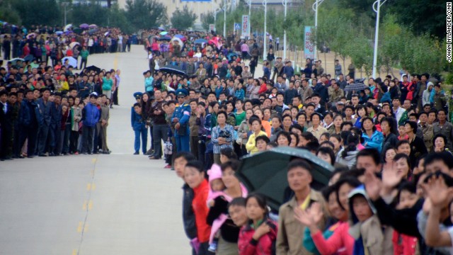 The streets of Rason were lined with thousands of people cheering, waving flags and taking photos with mobile phones.