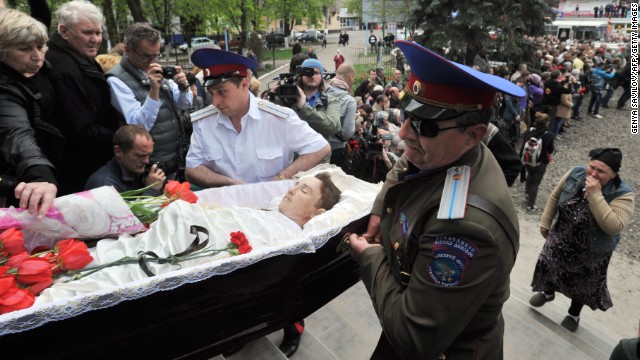 Cossacks carry a coffin into a church in Slovyansk on Tuesday, April 22, during a funeral for men killed in a gunfight at a checkpoint two days before.