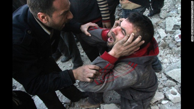 A man appears distraught after an air raid in Aleppo on Monday, December 23. 