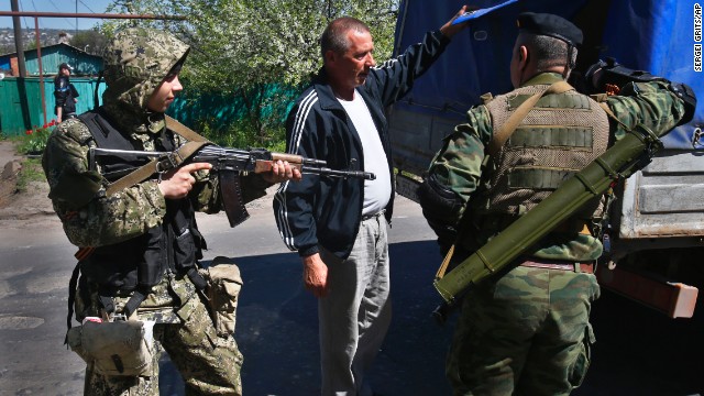 Pro-Russia armed militants inspect a truck near Slovyansk on Friday, April 25. Russian Foreign Minister Sergey Lavrov has accused the West of plotting to control Ukraine, and he said the pro-Russia insurgents in the southeast would lay down their arms only if the Ukrainian government clears out the Maidan protest camp in the capital, Kiev. 