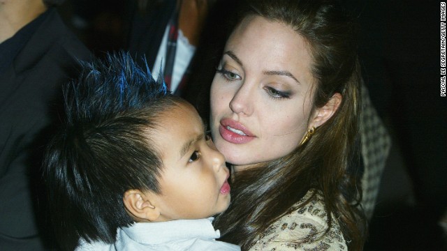 Jolie carries her son Maddox at the world premiere of "Shark Tale" in September 2004. 