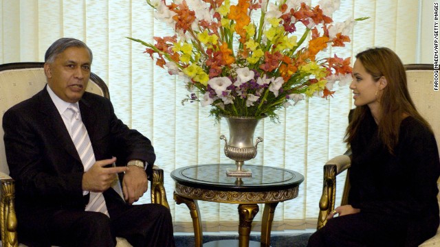 Jolie speaks with Pakistani Prime Minister Shaukat Aziz in Islamabad, Pakistan, in May 2005 as part of her role as goodwill ambassador for UNCHR. 