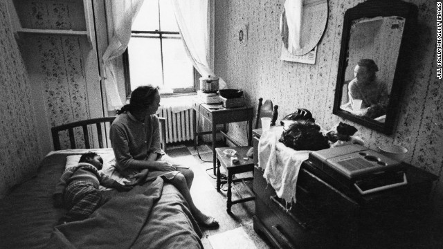 In 1971, a woman and child rest in their room at a New York City hotel for people living on welfare. Johnson's programs significantly reduced the poverty rate during his time in office, but it was still in the double digits (12.1%) when he left in 1969.