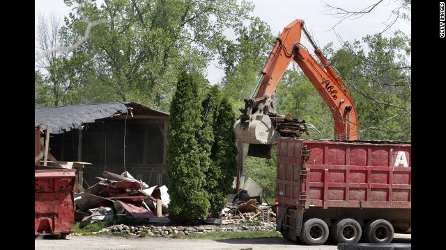 Demolition workers tear down a horse barn for the FBI in 2006 in a search for Hoffa's remains in Milford, Michigan. The FBI had received a tip that Hoffa was buried on the farm.