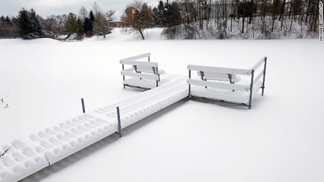 Snow piles up on a dock near a frozen pond in Carmel, Indiana, on February 5.
