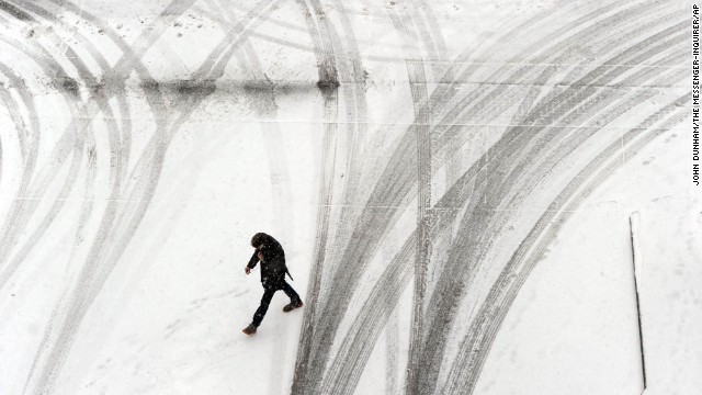 A person crosses a snowy parking garage in Owensboro, Kentucky, on February 4.