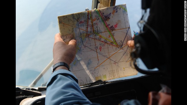 A member of the Vietnamese air force checks a map during continued search operations for a Malaysia Airlines jet near Phu Quoc Island off the coast of Vietnam on Tuesday, March 11. Contact with the Boeing 777-200 was lost as it flew over the South China Sea early Saturday after leaving Kuala Lumpur for Beijing. It was carrying 227 passengers and 12 crew members.