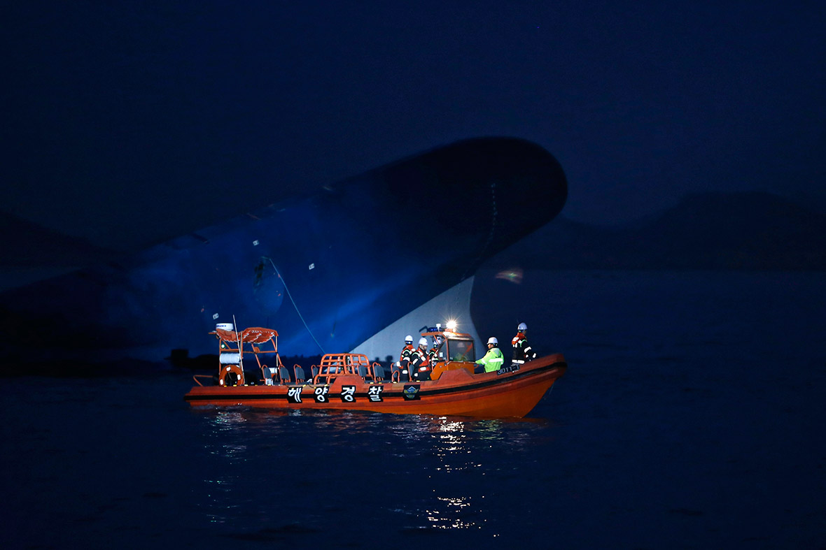 Maritime police search for missing passengers near the sunken Sewol