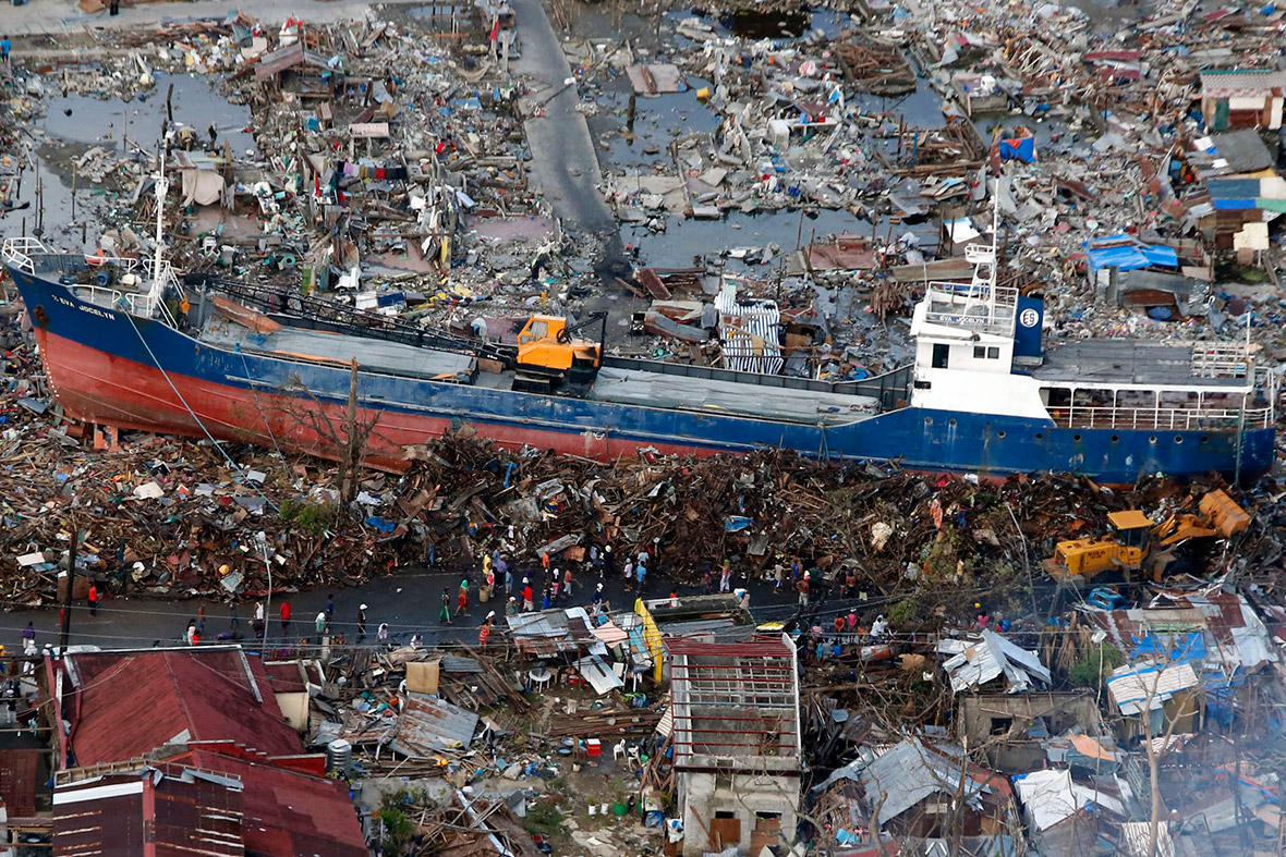 November 21, 2013: Residents look at a ship that was swept ashore by Typhoon Haiyan in Tacloban city