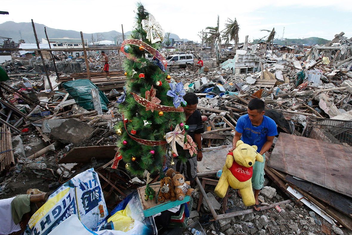 December 17, 2013 A typhoon survivor decorates a Christmas tree amid the rubble of destroyed houses in Tacloban city