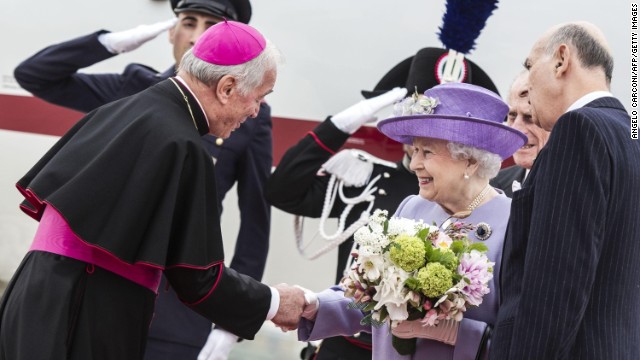 The Queen is welcomed by Archbishop Francesco Canalini at the Ciampino airport near Rome on April 3.