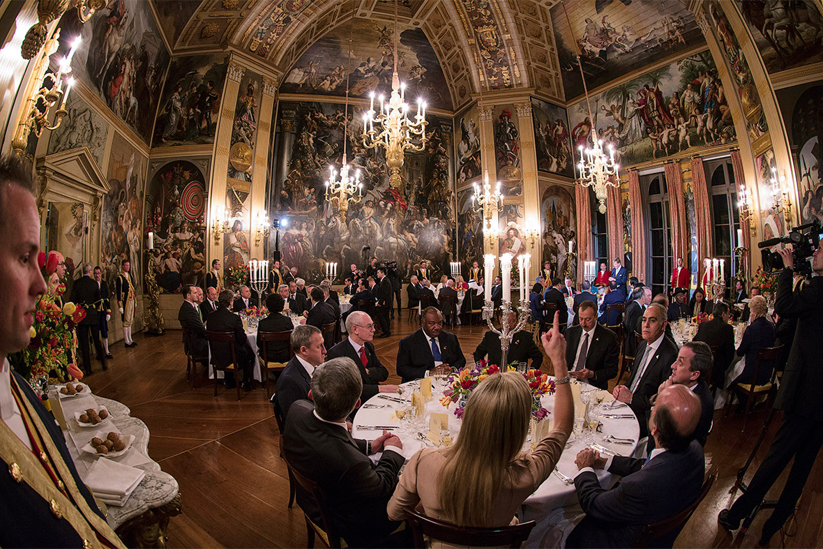 Queen Maxima of the Netherlands points to paintings on the ceiling of the Royal Palace Huis ten Bosch in the Hague during the official dinner for members of the Nuclear Security Summit