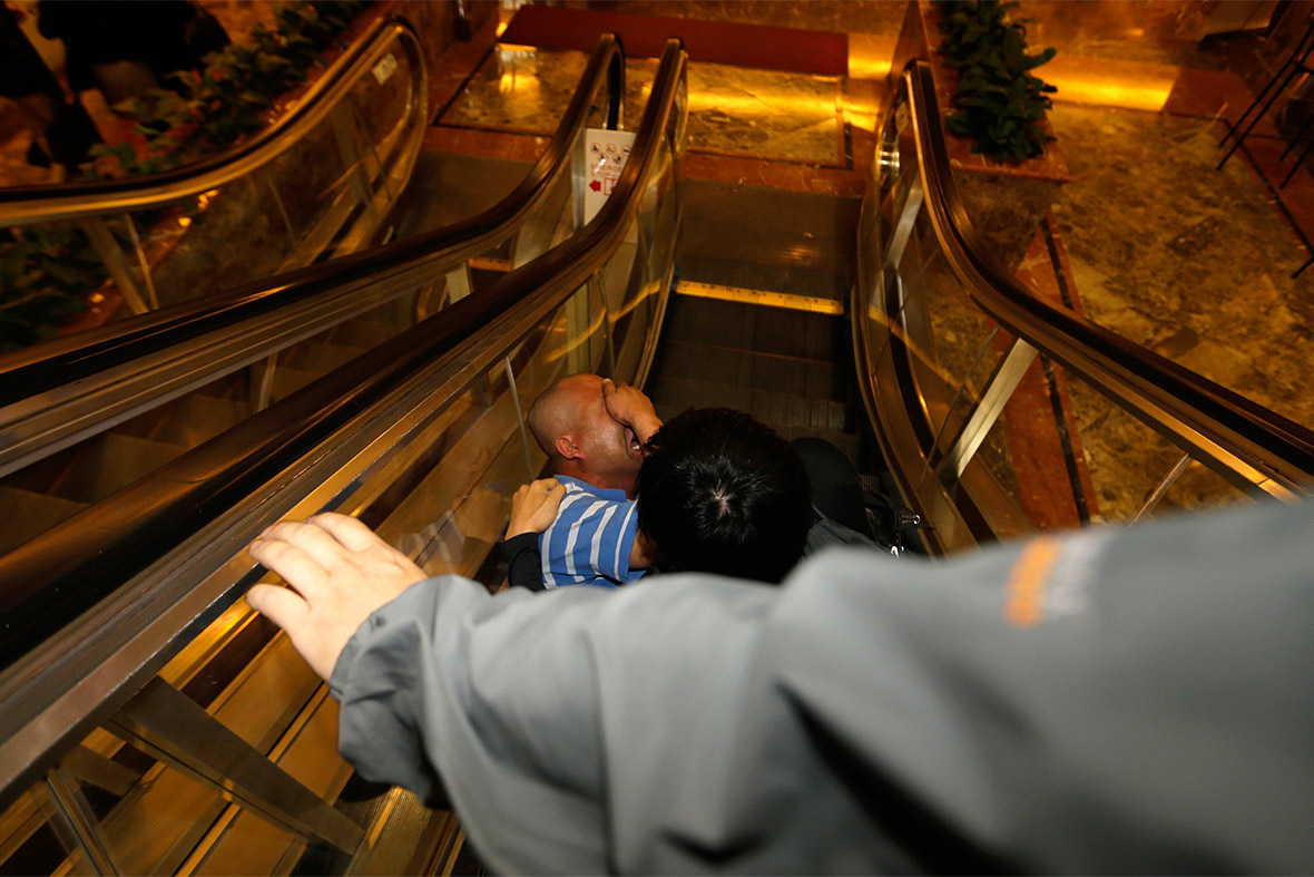 A relative collapses on an escalator at a hotel in Beijing after being told that there was no hope for passengers on the missing Malaysian airliner