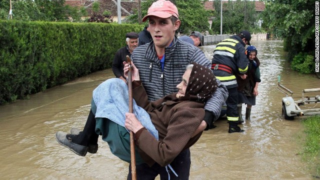 A Serbian rescuer carries an elderly woman out of her flooded house on Saturday, May 17 in the village of Obrez, Serbia, south of Belgrade. 