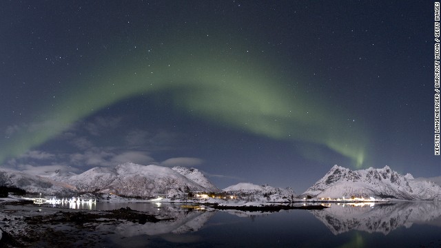 The aurora borealis lights up the night sky in Lofoten, Norway. The spectacular shows occur when charged particles from the solar wind interact with the Earth's atmosphere at the magnetic poles. 