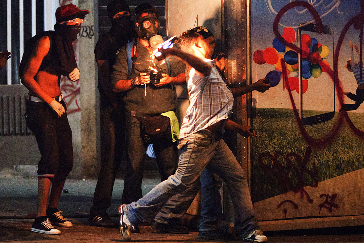 Anti-government demonstrators throw petrol bombs during clashes with the National Guard in Caracas