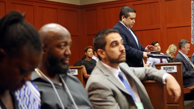 Zimmerman walks past Martin's parents, Sybrina Fulton, left, and Tracy Martin, second from left, as he enters the courtroom after lunch recess on June 26.