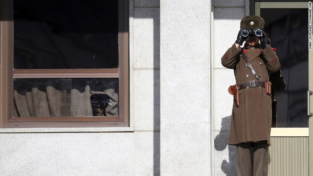 A North Korean soldier uses binoculars on Thursday, February 6, to look at South Korea from the border village of Panmunjom, which has separated the two Koreas since the Korean War. 