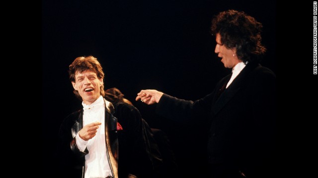 The Rolling Stones are inducted into the Rock and Roll Hall of Fame a year later. Mick Jagger and Keith Richards take the stage in 1989.