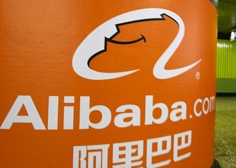 A pedestrian walks past Alibaba.com adve