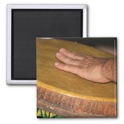 Pale hand on hand drum head skin magnets