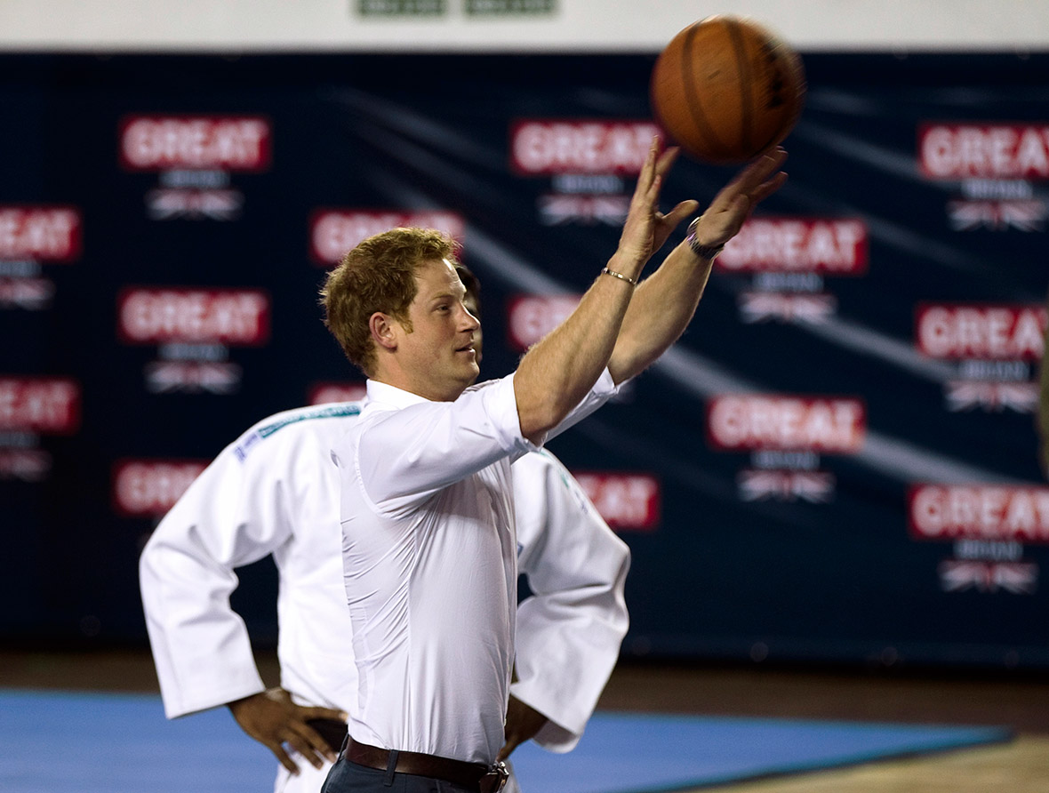 Prince Harry shoots a basketball during his visit to the Minas Tennis Club