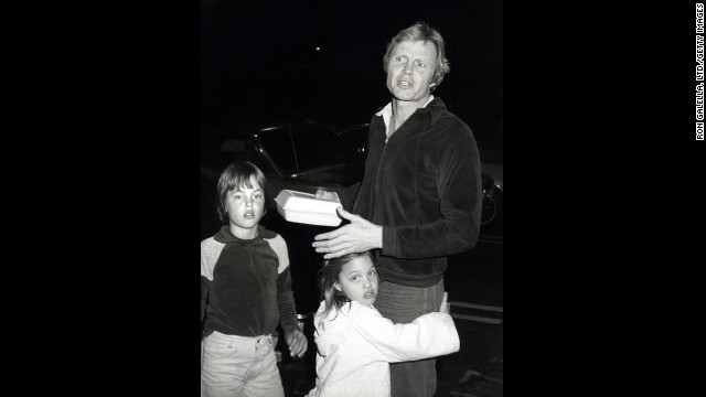 Jolie, center, hugs her father, Jon Voight, in Los Angeles in 1980. Her brother, James, is at left.