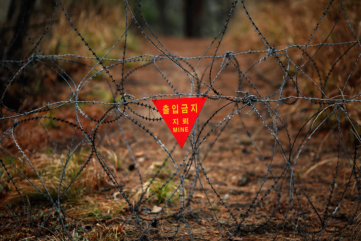 A sign warning of mines hangs on razor wire on the island of Baengnyeong.