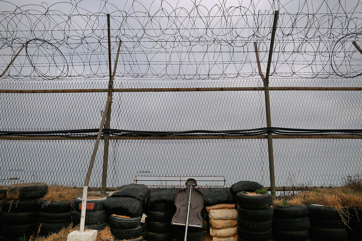 A dummy of a soldier is seen behind a fence on a beach facing North Korea on Yeonpyeong island.