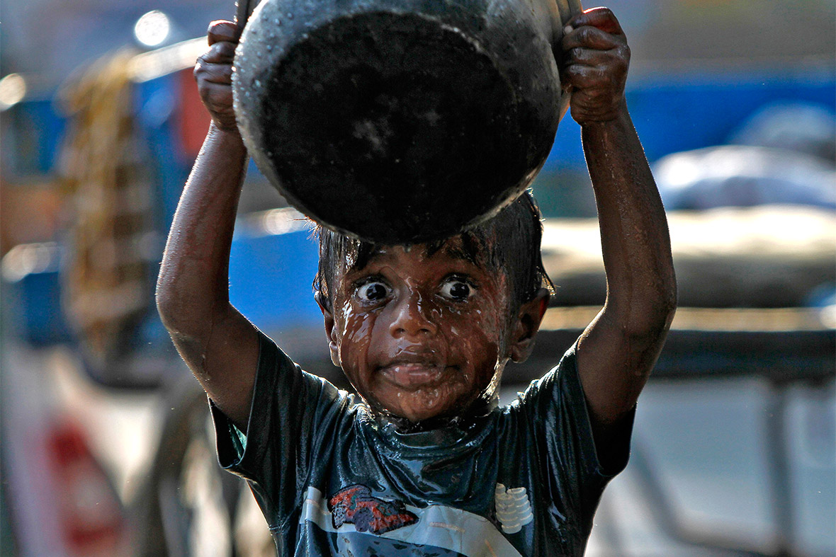 A boy bathes on a street in the southern Indian city of Chennai on World Water Day