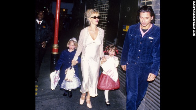 In 1996, Yates walks with Michael Hutchence, of INXS, and her daughters Peaches and Pixie Geldof. The following year, Hutchence was found dead in his hotel room.