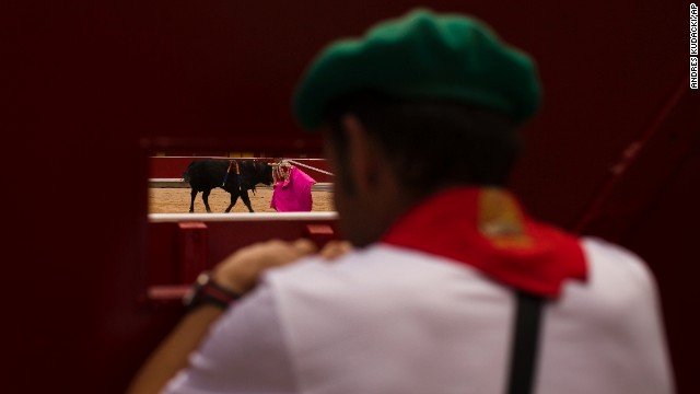 A worker watches a bullfight on July 8.