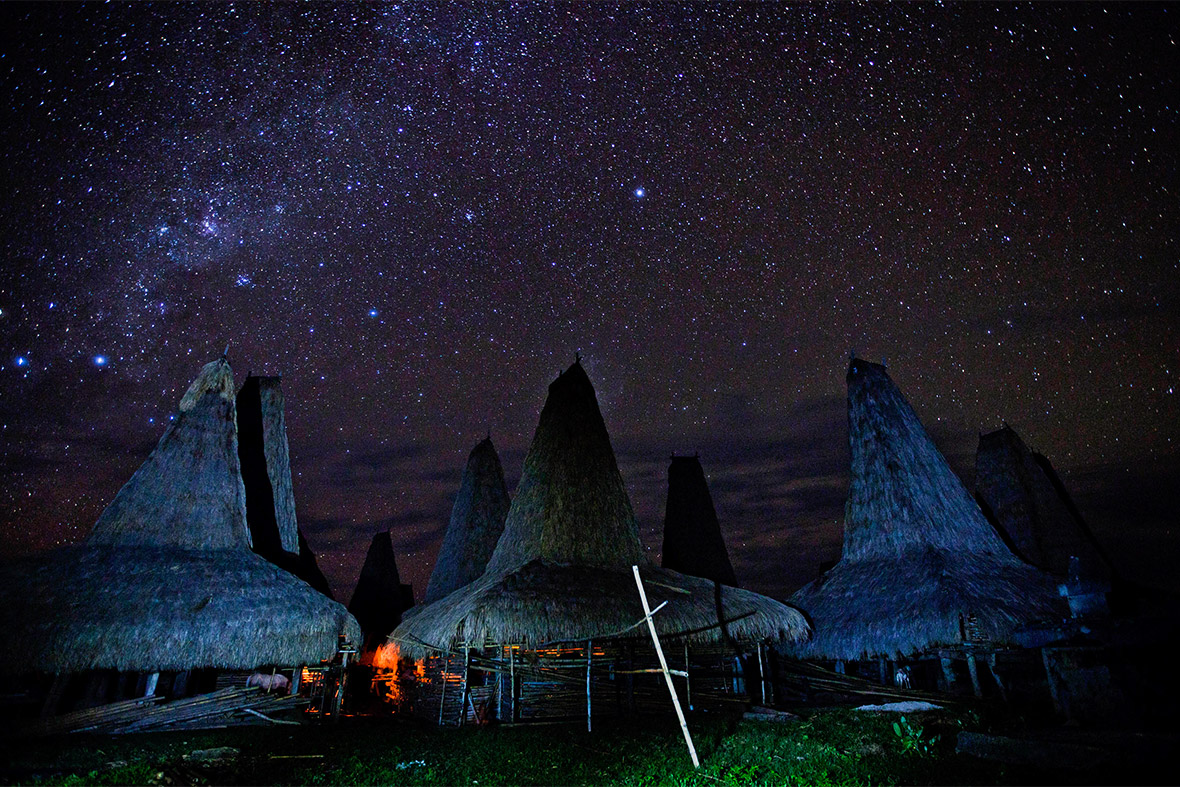 The Milky Way arcs over traditional houses in Wainyapu village on the island of Sumba, Indonesia, during the Pasola Festival, an event held every year to welcome the new harvest seaso