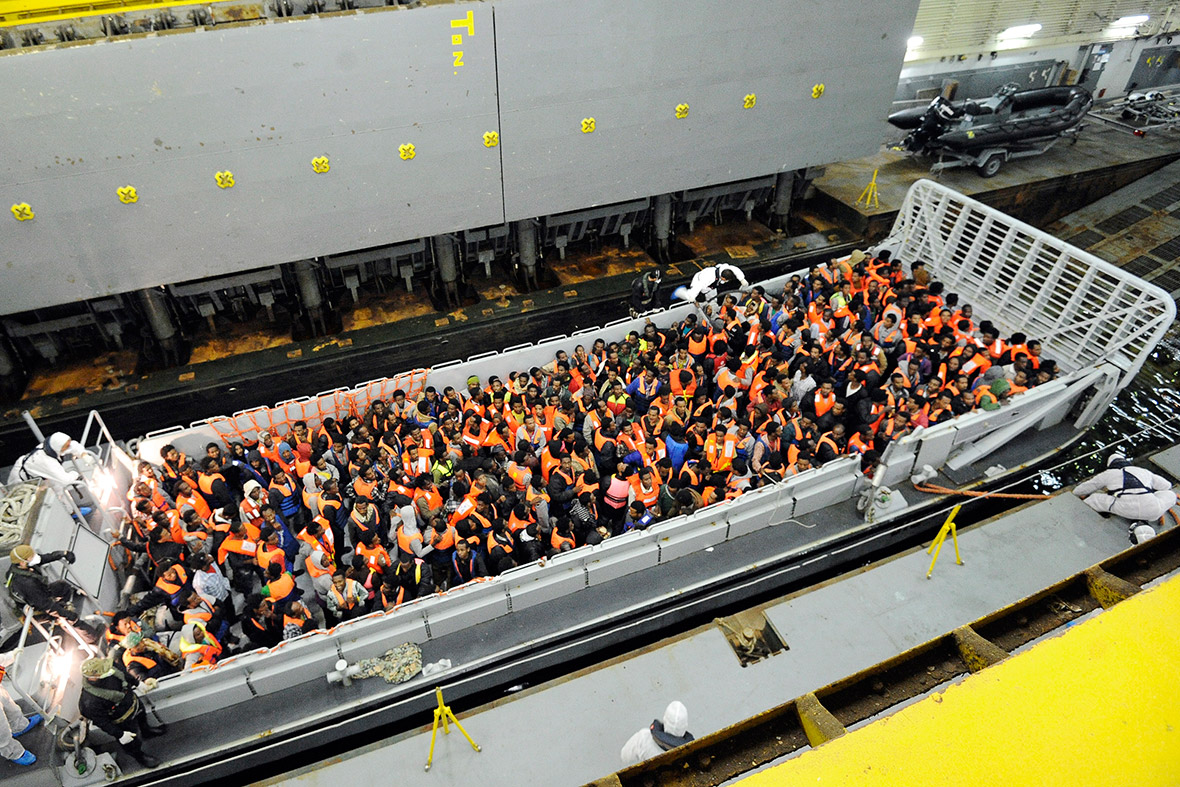 Around 250 African migrants are hoisted onto a landing craft of the Italian Navy ship San Giorgio after being rescued in open international waters in the Mediterranean Sea between the Italian and the Libyan coasts