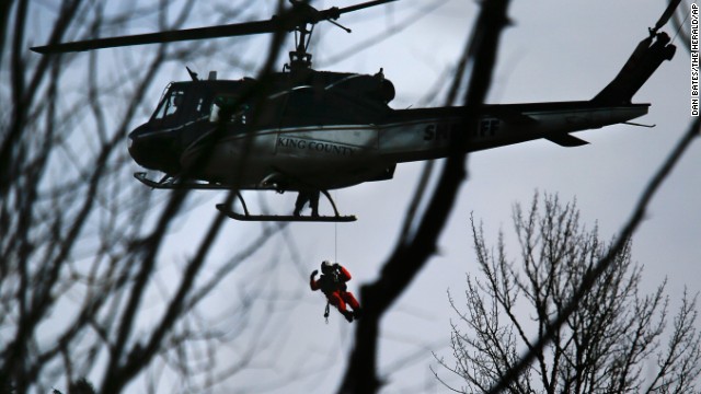 A King County Sheriff helicopter lowers a rescue worker on March 24.