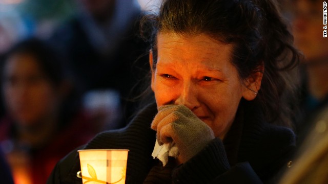 Teresa Welter cries during a candlelight vigil in Arlington on Tuesday, March 25.