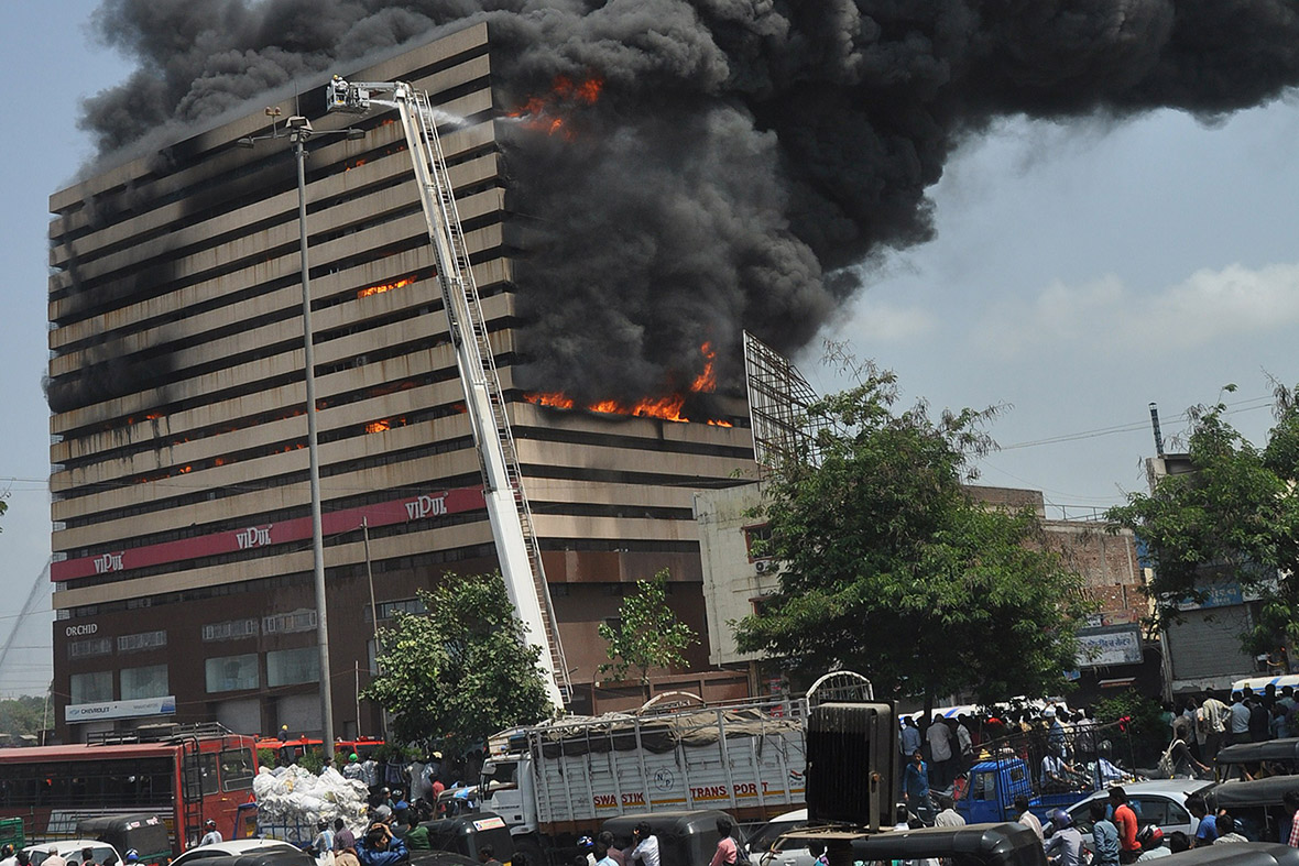Rescue workers attempt to control a fire at the Orchid Towers in Surat, some 270km from Ahmedabad, India