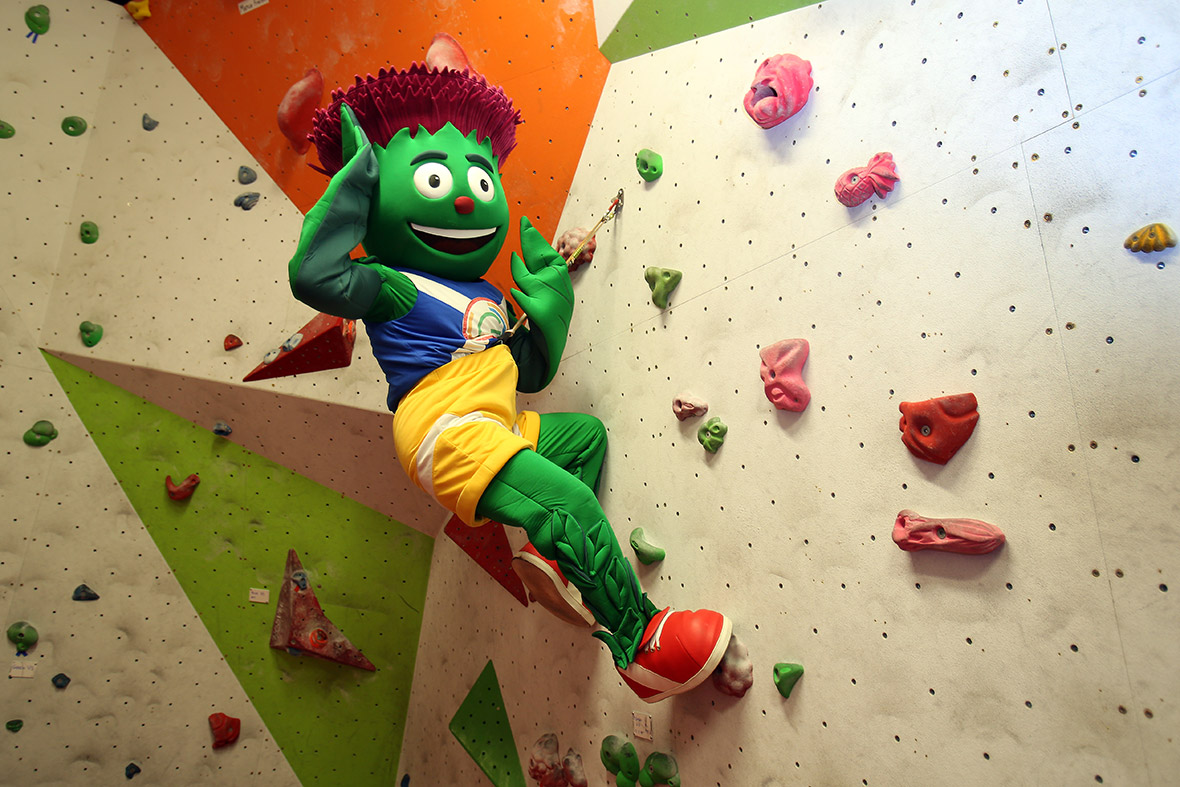 Clyde the 2014 Commonwealth Games Mascot holds the Queen's Baton at the Beacon Climbing Centre, Wales during the Glasgow 2014 Baton Relay
